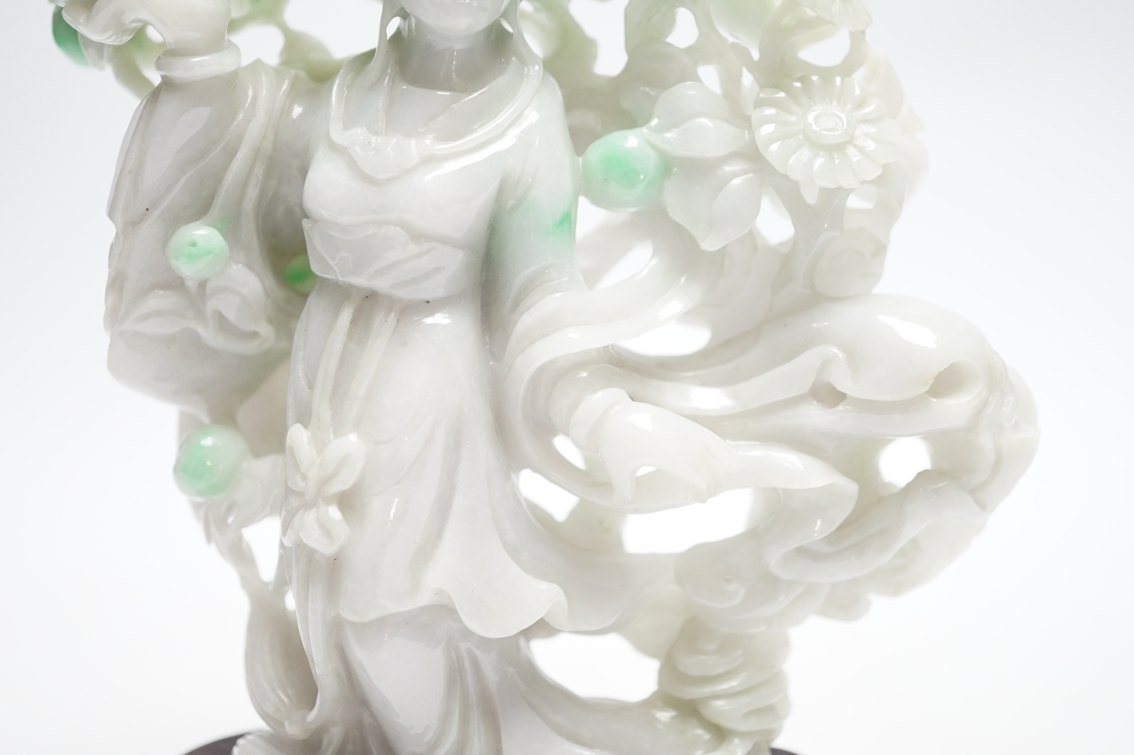 A Chinese jadeite figure of He Xiangu on carved stand, 17cm high